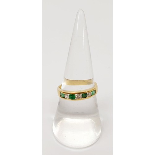 10 - An 18ct gold ring set with diamonds and green stones, gross weight 2.8g, size O. UK shipping £14.