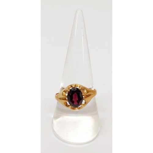 25 - A hallmarked 9ct gold ring set with a red stone in a gypsy setting, gross weight 2.7, size U. UK shi... 