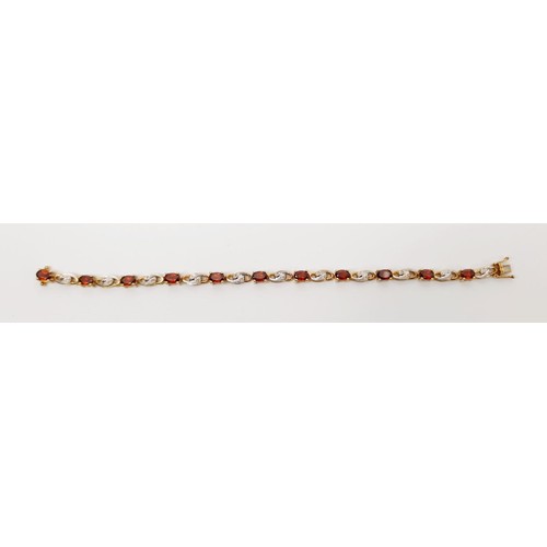 34 - A hallmarked 9ct gold bracelet set with diamonds and red stones, gross weight 10.3g, length 18cm. UK... 