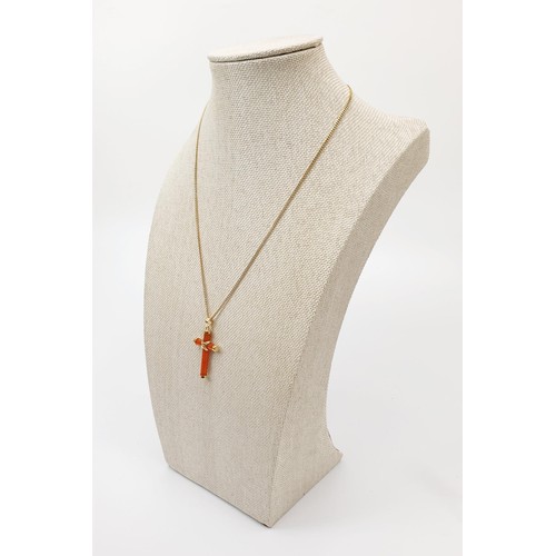 38 - A carnelian and 14ct gold cross on a hallmarked 9ct gold chain, chain length 43cm, gross weight 5.1g... 