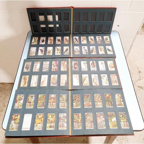 69 - A selection of cigarette card albums. UK shipping £14.