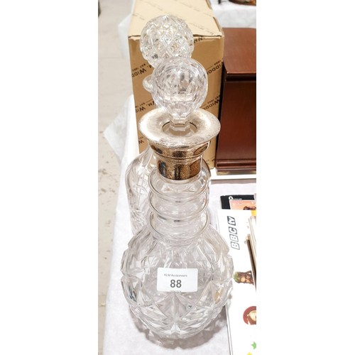 88 - A cut crystal decanter with a hallmarked silver collar A/F, together with a cranberry lustre, A/F an... 