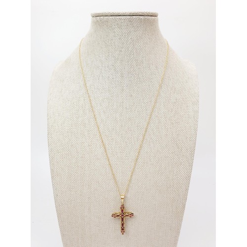 71 - A 9ct gold lattice work cross set with red stones on a 9ct gold chain, chain length 44cm, gross weig... 