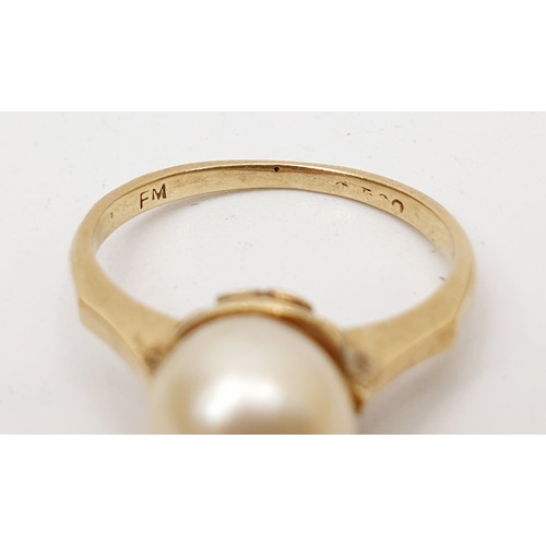 64 - A yellow metal (mark rubbed) and pearl ring, gross weight 2.5g, size L/M. UK shipping £14.