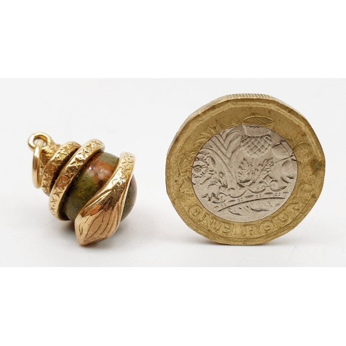 32 - A yellow metal and hard stone snake charm, length 2.5cm, gross weight 7.7g. UK shipping £14.