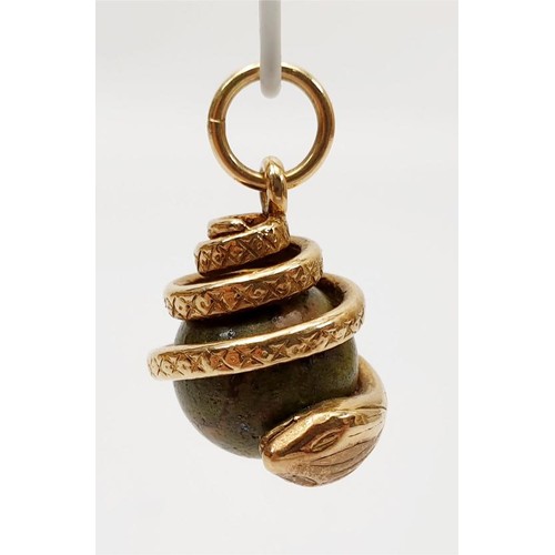 32 - A yellow metal and hard stone snake charm, length 2.5cm, gross weight 7.7g. UK shipping £14.