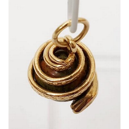 32 - A yellow metal and hard stone snake charm, length 2.5cm, gross weight 7.7g. UK shipping £14.