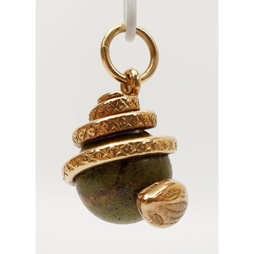 32 - A yellow metal and hard stone snake charm, length 2.5cm, gross weight 7.7g. UK shipping £14.