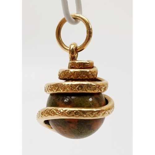 32 - A yellow metal and hard stone snake charm, length 2.5cm, gross weight 7.7g. UK shipping £14.
