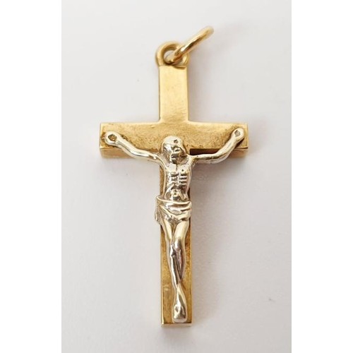 27 - A hallmarked 9ct yellow and white gold crucifix pendant, length 3.5cm, weight 4g. UK shipping £14.