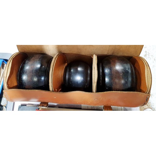 82 - A cased set of Thomas Taylor lawn bowls. UK shipping £14.