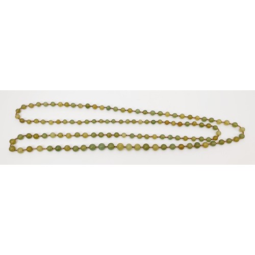 40 - A vintage string of jade beads, length 158cm. UK shipping £14.