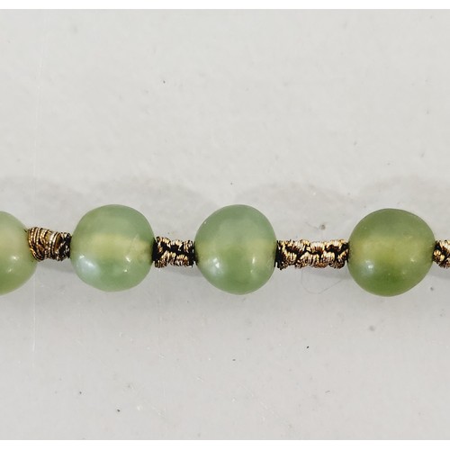 40 - A vintage string of jade beads, length 158cm. UK shipping £14.