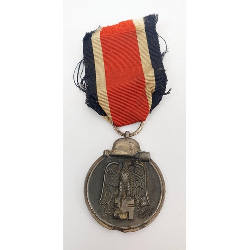 229 - WWII German replica medals: Luftschutz Medal, Two Merit Crosses with Swords and Eastern Front medal.... 