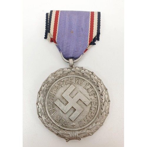 229 - WWII German replica medals: Luftschutz Medal, Two Merit Crosses with Swords and Eastern Front medal.... 