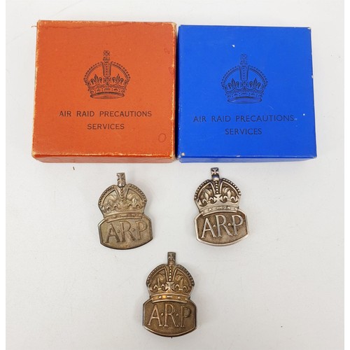 231 - Two WWII hallmarked silver ARP wardens lapel badges in presentation boxes and silver ARP pin badge. ... 