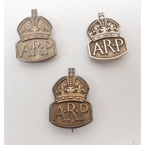 231 - Two WWII hallmarked silver ARP wardens lapel badges in presentation boxes and silver ARP pin badge. ... 