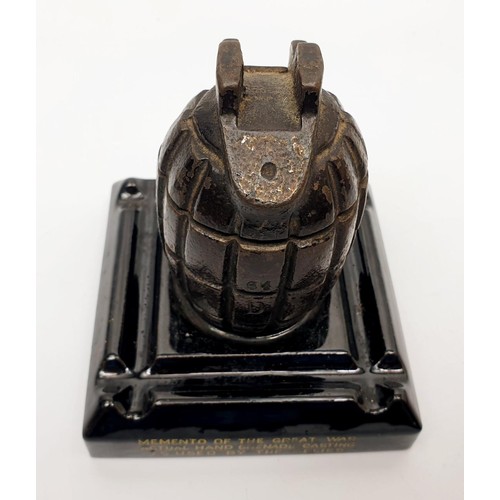 146 - A WWI memento ink stand made from a casting of a British Mills bomb, 11cm high. UK shipping £14.