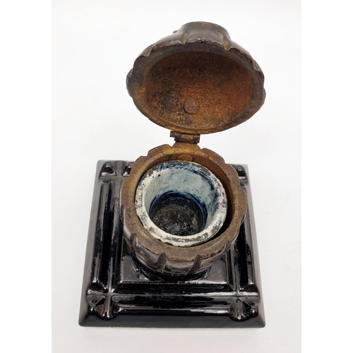 146 - A WWI memento ink stand made from a casting of a British Mills bomb, 11cm high. UK shipping £14.