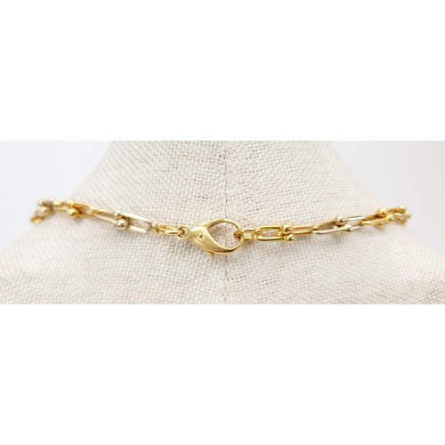 13 - An 18ct yellow and white gold chain, length 92cm, weight 71g.