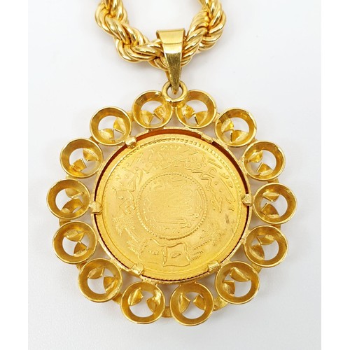 14 - A Saudi Arabian gold Guinea coin in an 18ct gold pendant mount on an 18ct gold chain, chain length 8... 