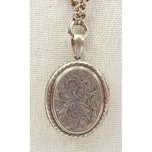 30 - An antique silver plated locket, length 5.5cm on a white metal chain, length 47cm. UK shipping £14.