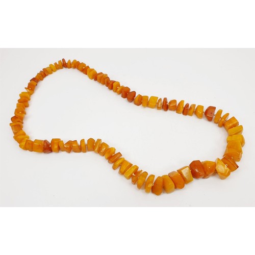 34 - A butterscotch amber bead necklace, length 72cm, weight 87g. UK shipping £14.