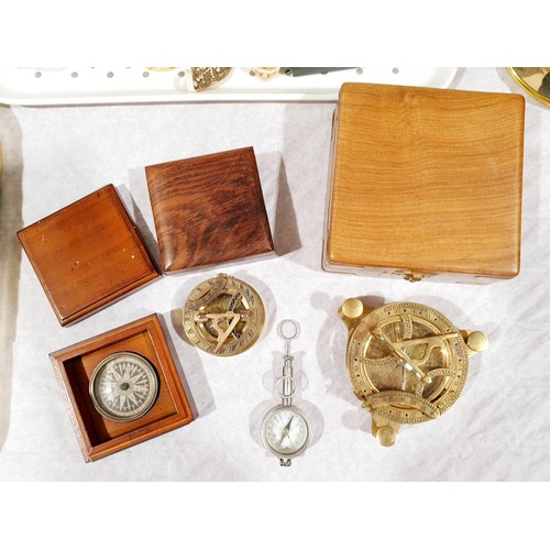 59 - A brass sundial in a wooden case, one smaller sundial, a compass and a compass with label 