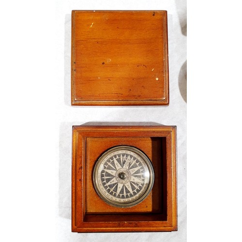 59 - A brass sundial in a wooden case, one smaller sundial, a compass and a compass with label 