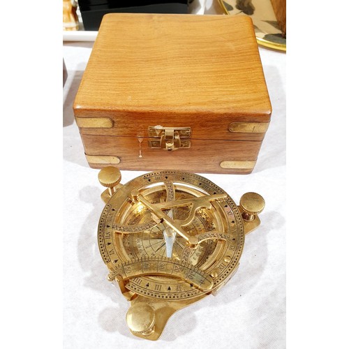 59 - A brass sundial in a wooden case, one smaller sundial, a compass and a compass with label 