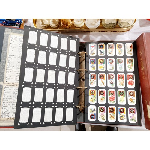 129 - A folder of cigarette cards and tea cards including The Beano, film and TV stars.  UK shipping £14.