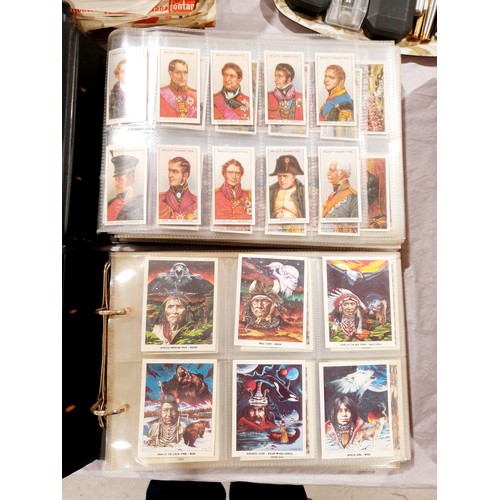 132 - Two folders of tea, cigarette and bubblegum cards wild west. UK shipping £14.