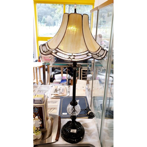 153 - An Interiors 1900 table lamp with Tiffany style shade, metal and cut glass column on a marble base, ... 