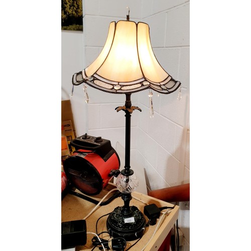 153 - An Interiors 1900 table lamp with Tiffany style shade, metal and cut glass column on a marble base, ... 