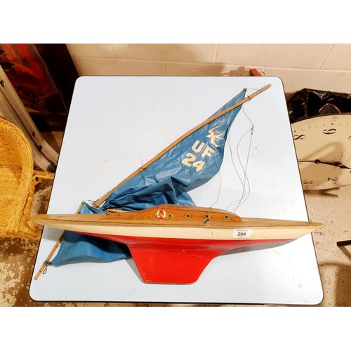 204 - A vintage wood and plastic Ufea Fox pond yacht, length 60cm together with a Binatone TV/video game. ... 