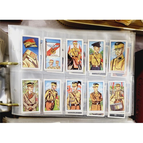 130 - A folder of military cigarette and tea cards including uniforms of the Third Reich. UK shipping £14.