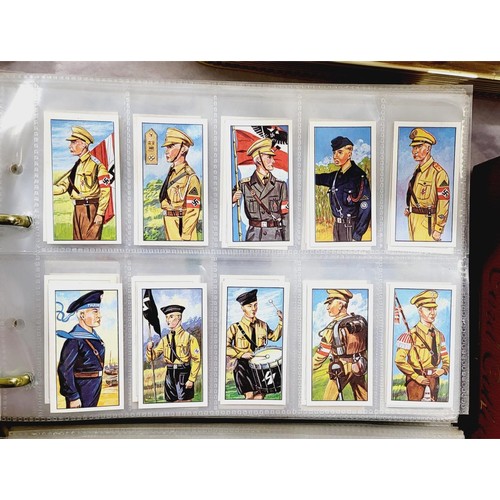 130 - A folder of military cigarette and tea cards including uniforms of the Third Reich. UK shipping £14.