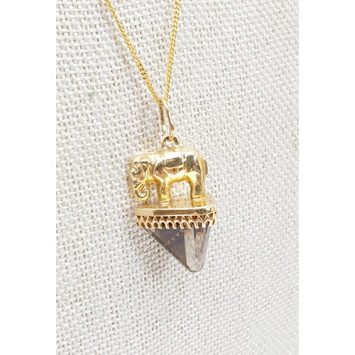 6 - A hallmarked 9ct gold elephant and smokey quartz pendant, length 3.5cm on a 9ct gold chain, chain le... 