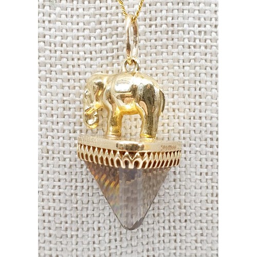 6 - A hallmarked 9ct gold elephant and smokey quartz pendant, length 3.5cm on a 9ct gold chain, chain le... 