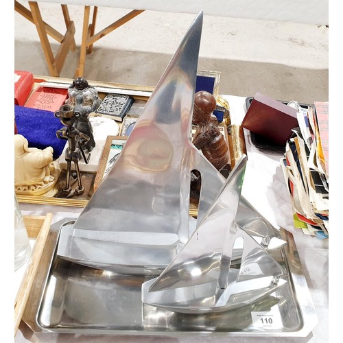 110 - An aluminium model of a sailing boat by Nauticalia of London, height 38cm together with matching sma... 