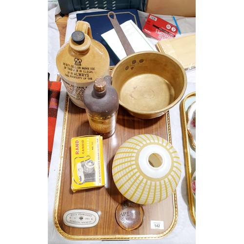 142 - A tray of assorted including a vintage advertising paper weight for Apenta Water, a brass pan and st... 