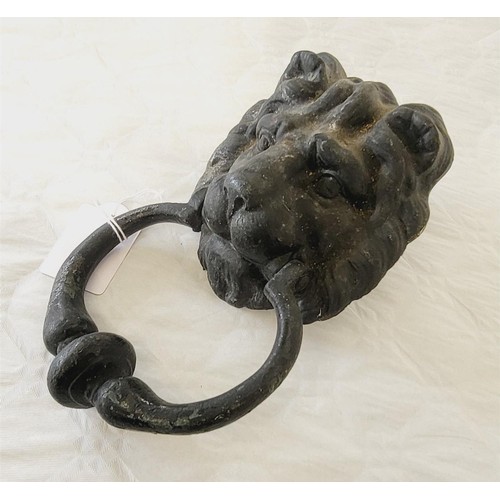 256 - An antique cast iron lion's head door knocker, length 23cm. UK shipping £14.