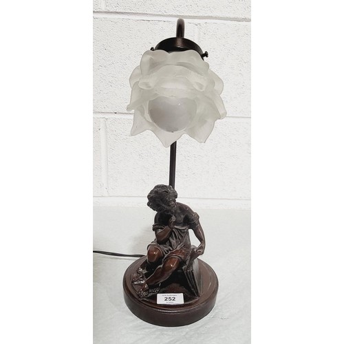 252 - A resin table lamp with a figure of a boy, shade A/F, height 42cm. No shipping. Arrange collection o... 