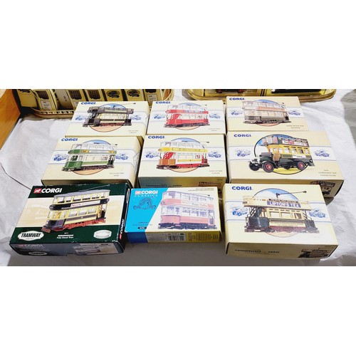 185 - Boxed Corgi trams and a bus together with a display stand which is A/F. UK shipping £14.