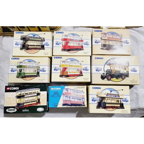 185 - Boxed Corgi trams and a bus together with a display stand which is A/F. UK shipping £14.