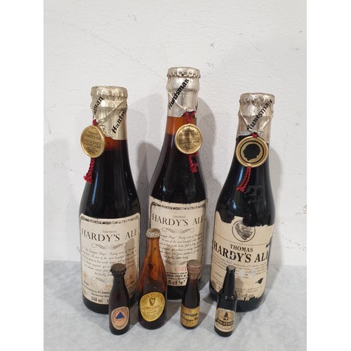 12 - Three bottles of Thomas Hardy's Ale, 1980 & 1981, with four miniature Guinness and Mackesons bottles... 