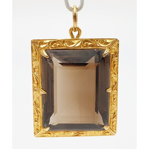 43 - A smokey quartz in a yellow metal pendant mount, A/F, length 4cm. UK shipping £14.