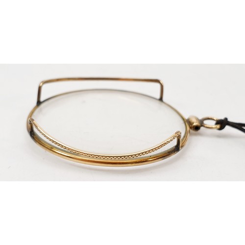 55 - A vintage gold plated monocle, diameter 4cm. UK shipping £14.