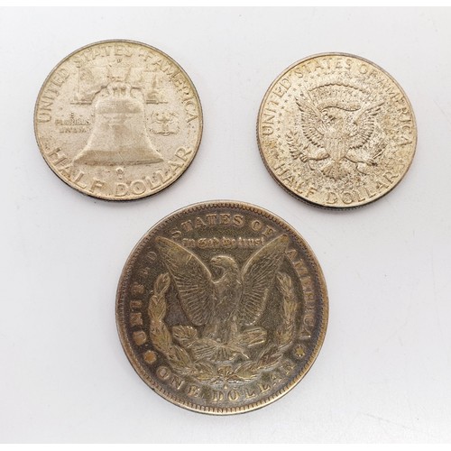 69 - An 1878 Morgan silver dollar together with a 1958 Liberty Bell half dollar and a 1964 Kennedy half d... 