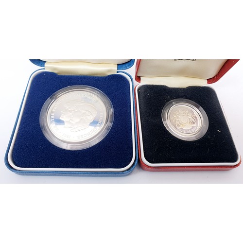 64 - A cased silver proof £1 coin together with four cased silver proof commemorative crowns for the Silv... 